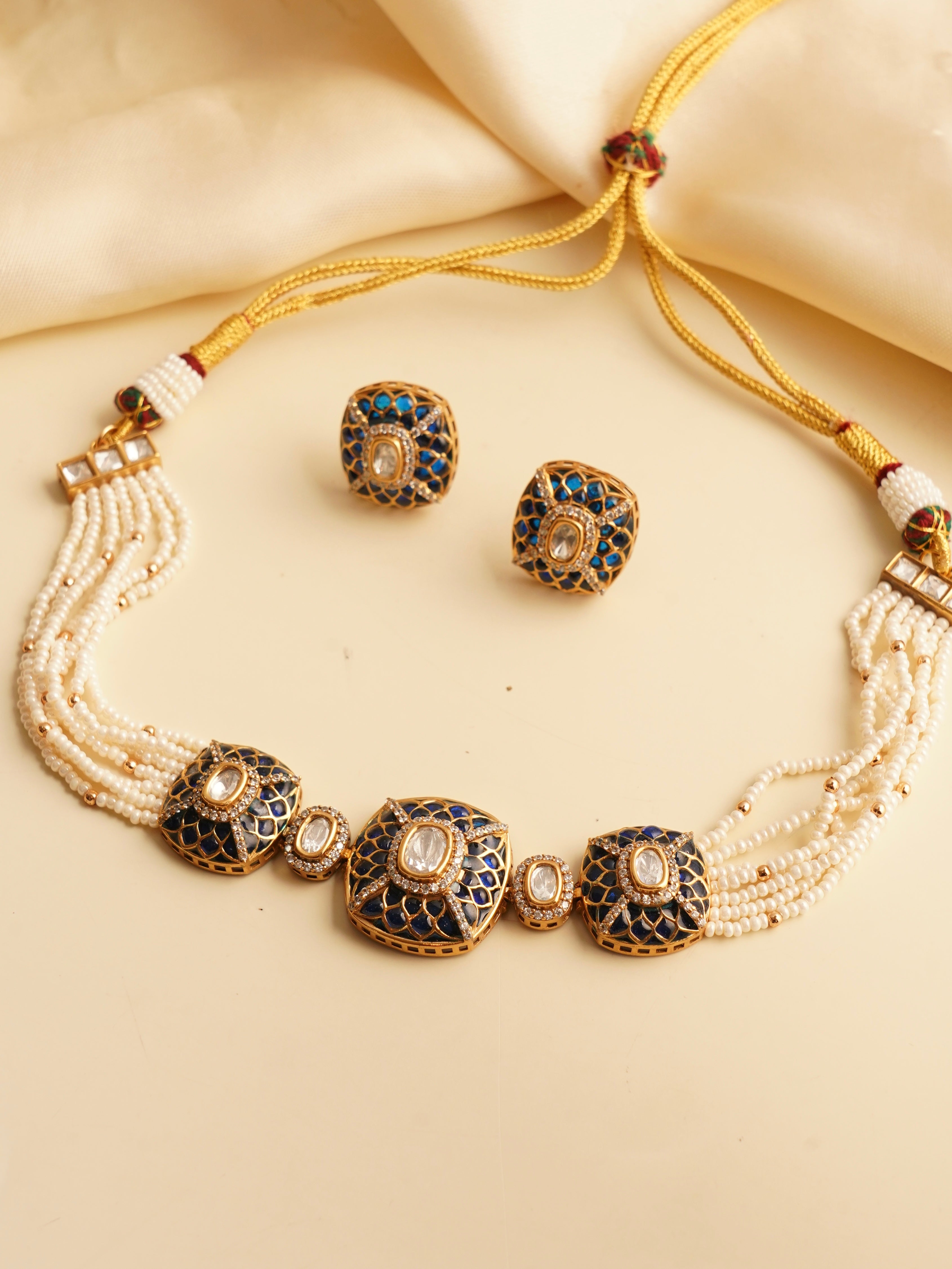 Close-up of enamel-detailed choker with layered pearls and Kundan diamond accents